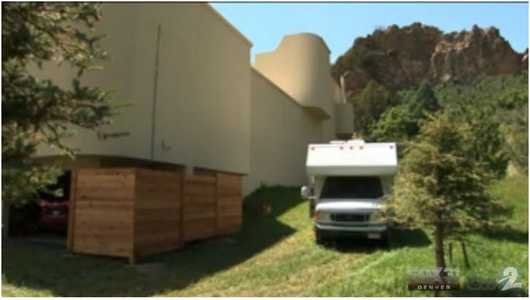 Image: An RV parked next to the side of a large, modern house. The house dwarfs the size of the RV. The photo contains the logo of Fox 31 Denver.